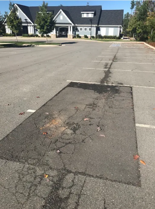 Before parking lot repair for an HOA project near Midlothian, VA, where Finley Asphalt & Concrete delivered a fresh, durable parking lot through expert sealcoating and attention to detail.